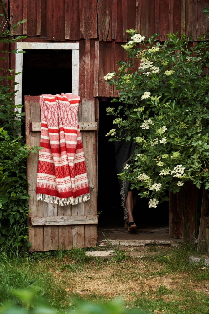 Freja Red Wool Blanket Hanging on a Door