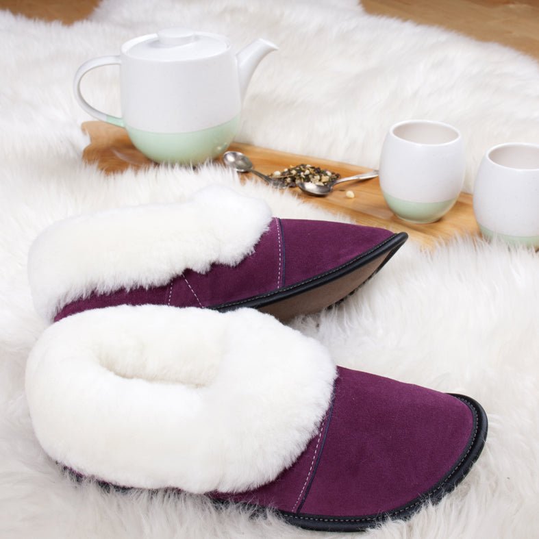 
            
                Load image into Gallery viewer, Plum Sheepskin Slippers on a Longwool Rug
            
        